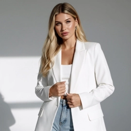 Woman in white blazer and jeans.